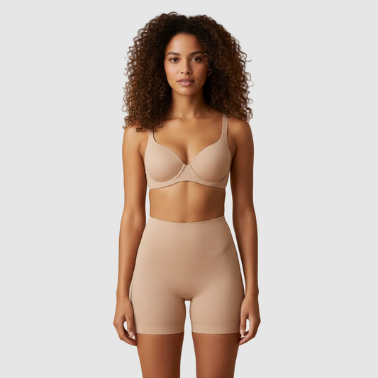 Studio photo, same female model, 28 years old, vol tan skin, tight natural curls. Wearing nude high-waisted sculpt shorts and matching bra. Front view. High-waisted sculpt shorts ending mid-thigh, approx 8–10 cm above the knee, straight hem. Smooth compression. Clean light beige background. Ultra realistic. 800x800.